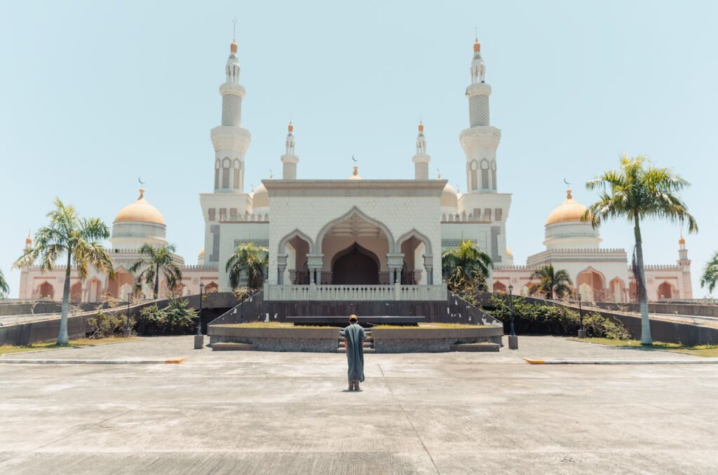 Front view of the Grand Mosque of Cotabato with mesmerizing minarets and palm trees.